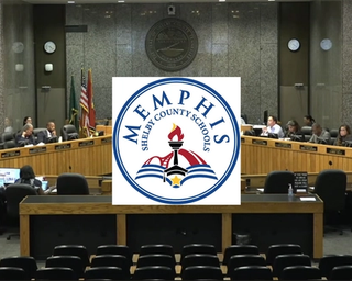 Commissioners sitting at a meeting with the logo of Memphis-Shelby County Schools