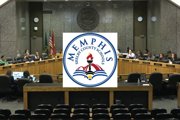 Commissioners sitting at a meeting with the logo of Memphis-Shelby County Schools