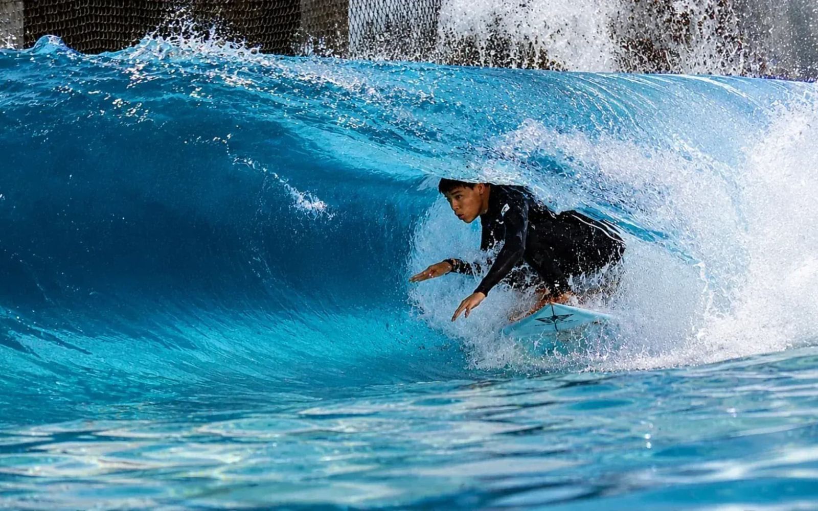 A surfer in the barrel on Surf Center's heated indoor wave.