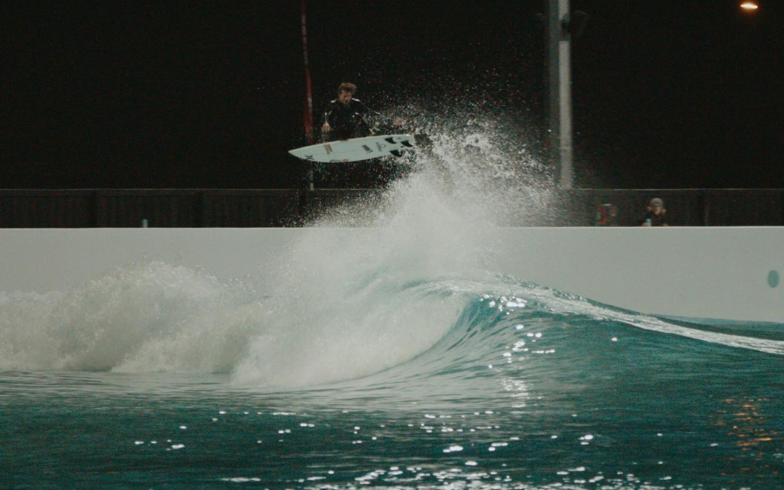 A punt under the lights during an evening session at URBNSURF Melbourne.