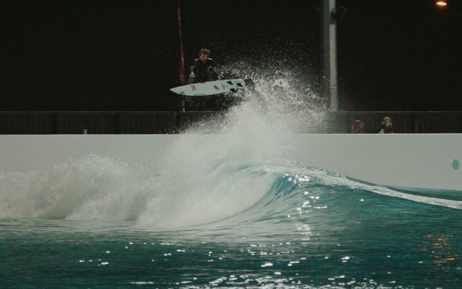 A punt under the lights during an evening session at URBNSURF Melbourne.