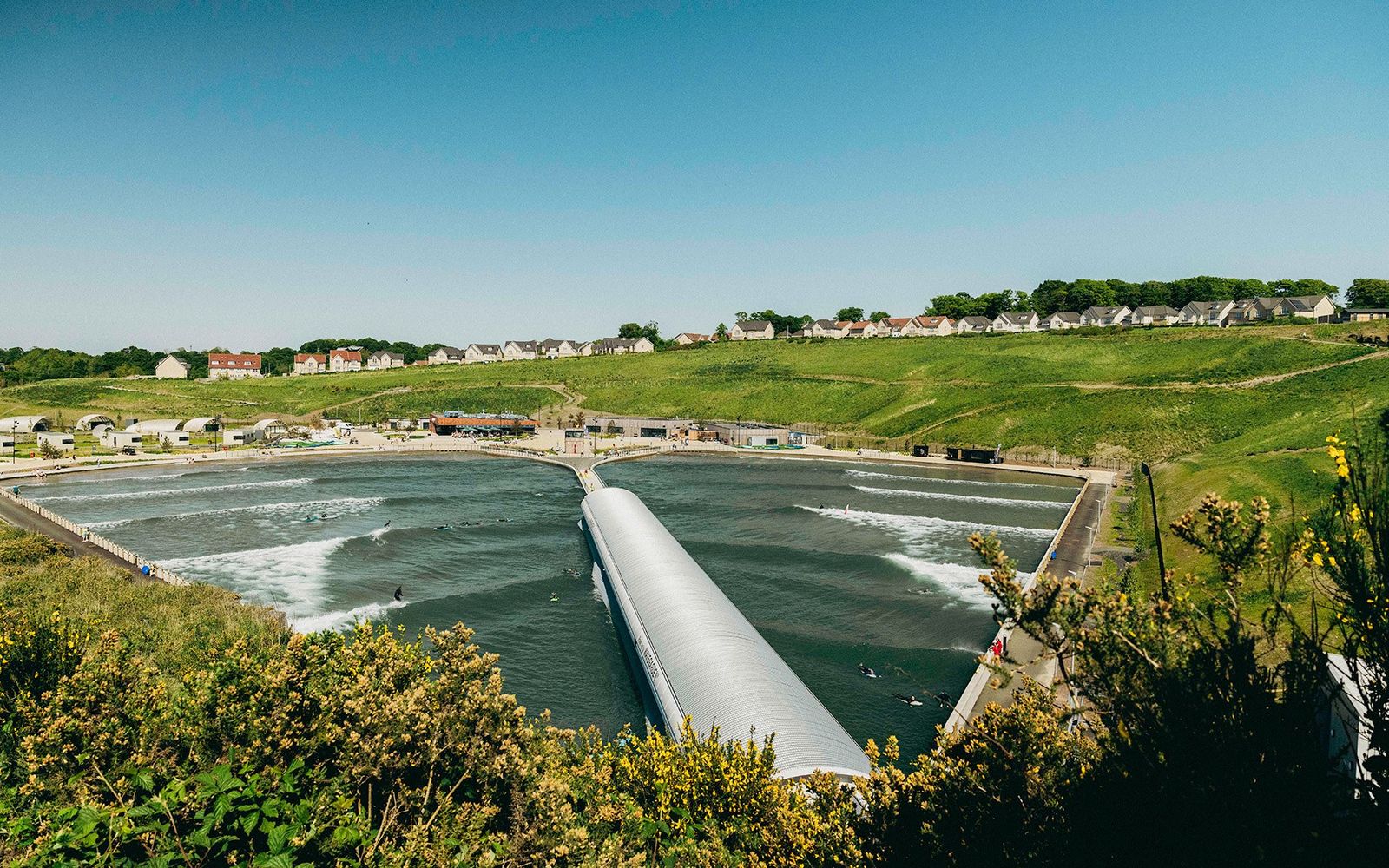 Lost Shore's lagoon from above at Ratho, on the western edge of Edinburgh, with the pier dividing its two sides.