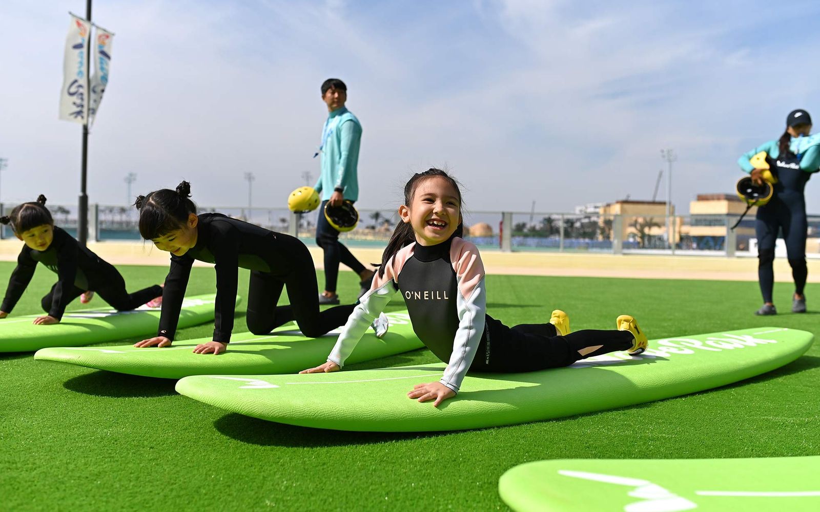 A beginner lesson on the turf at Wave Park in Siheung, practising pop-ups before getting in the water.