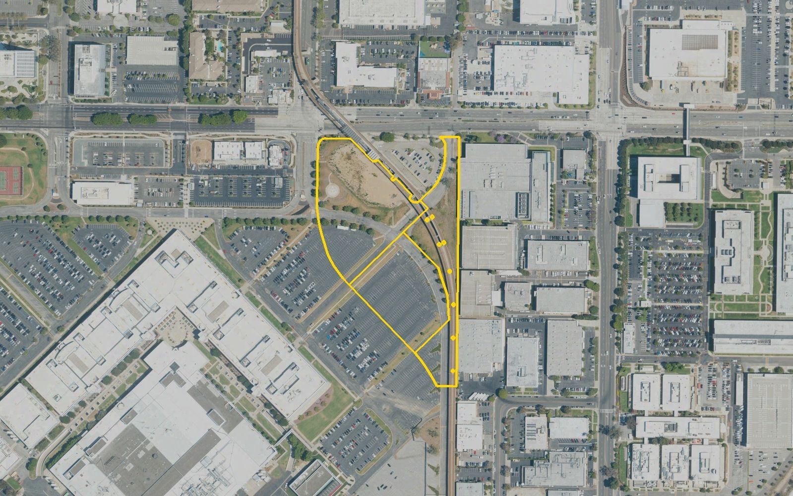 The El Segundo site in May 2022, outlined in yellow from Los Angeles County parcel records: a strip between Nash Street and the elevated Metro K Line, south of El Segundo Boulevard.