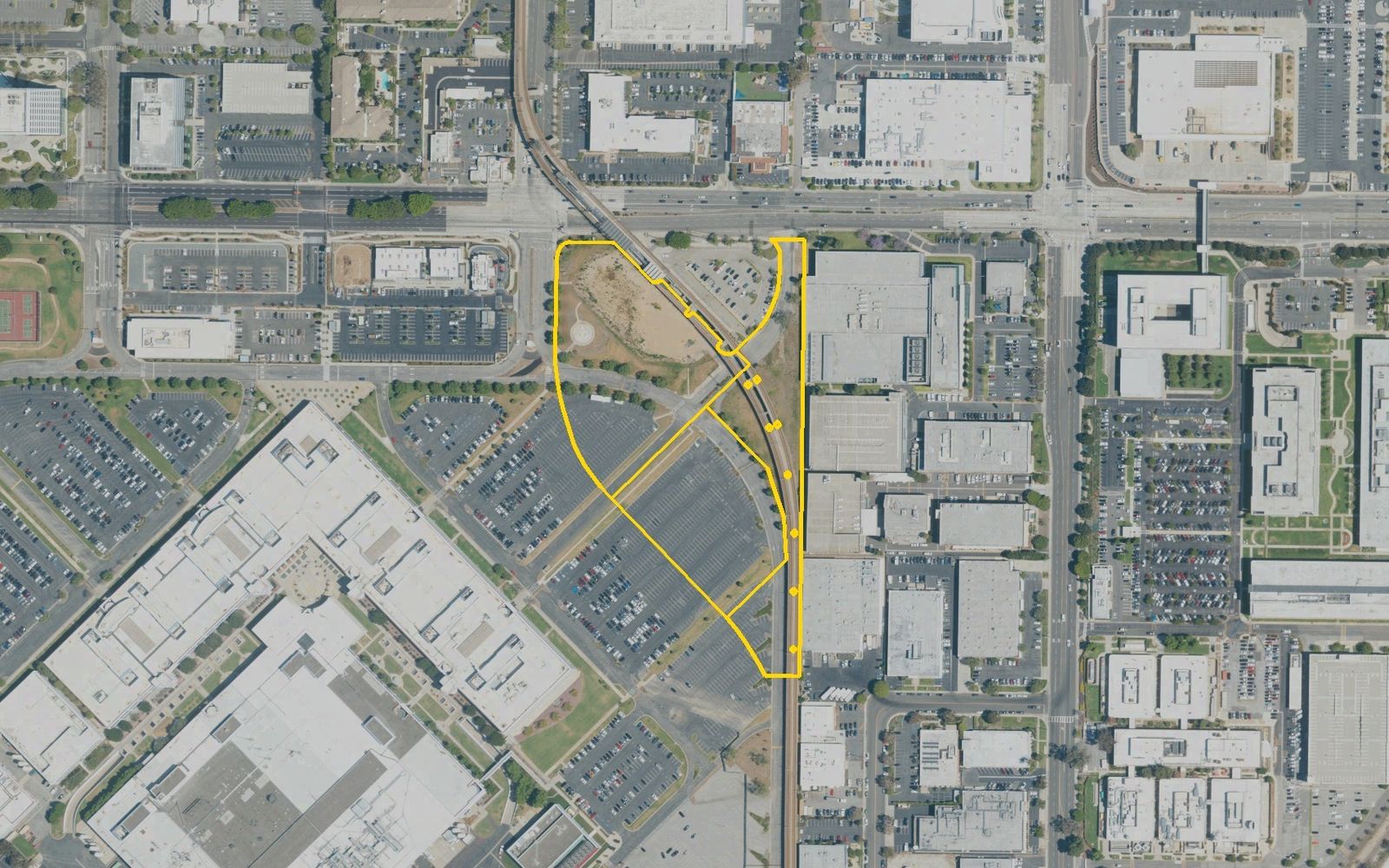 The El Segundo site in May 2022, outlined in yellow from Los Angeles County parcel records: a strip between Nash Street and the elevated Metro K Line, south of El Segundo Boulevard.