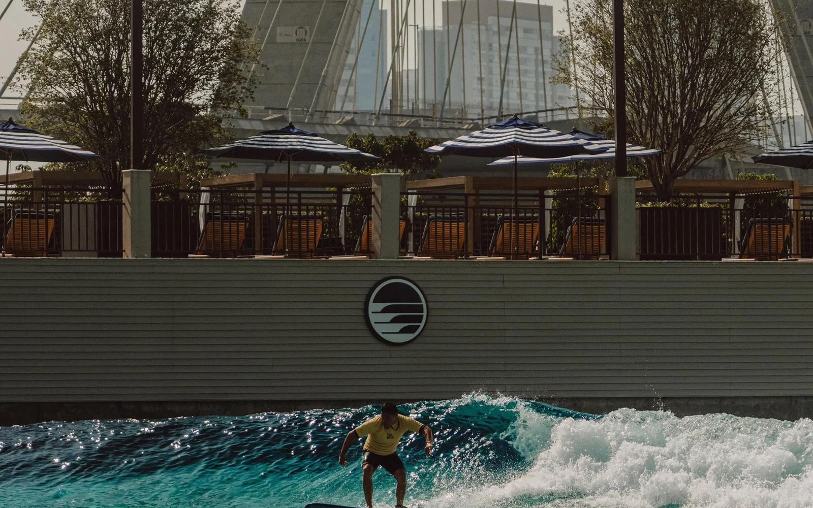 A surfer on São Paulo Surf Club's PerfectSwell pool, below the cables of the Estaiada bridge.