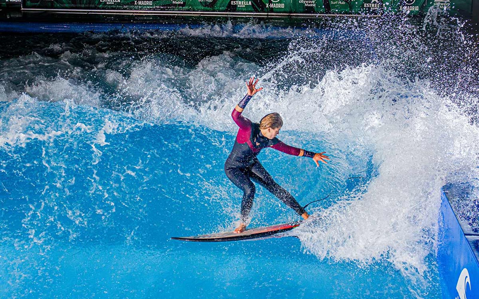 A surfer carving on Honna Surf Hub's standing wave.