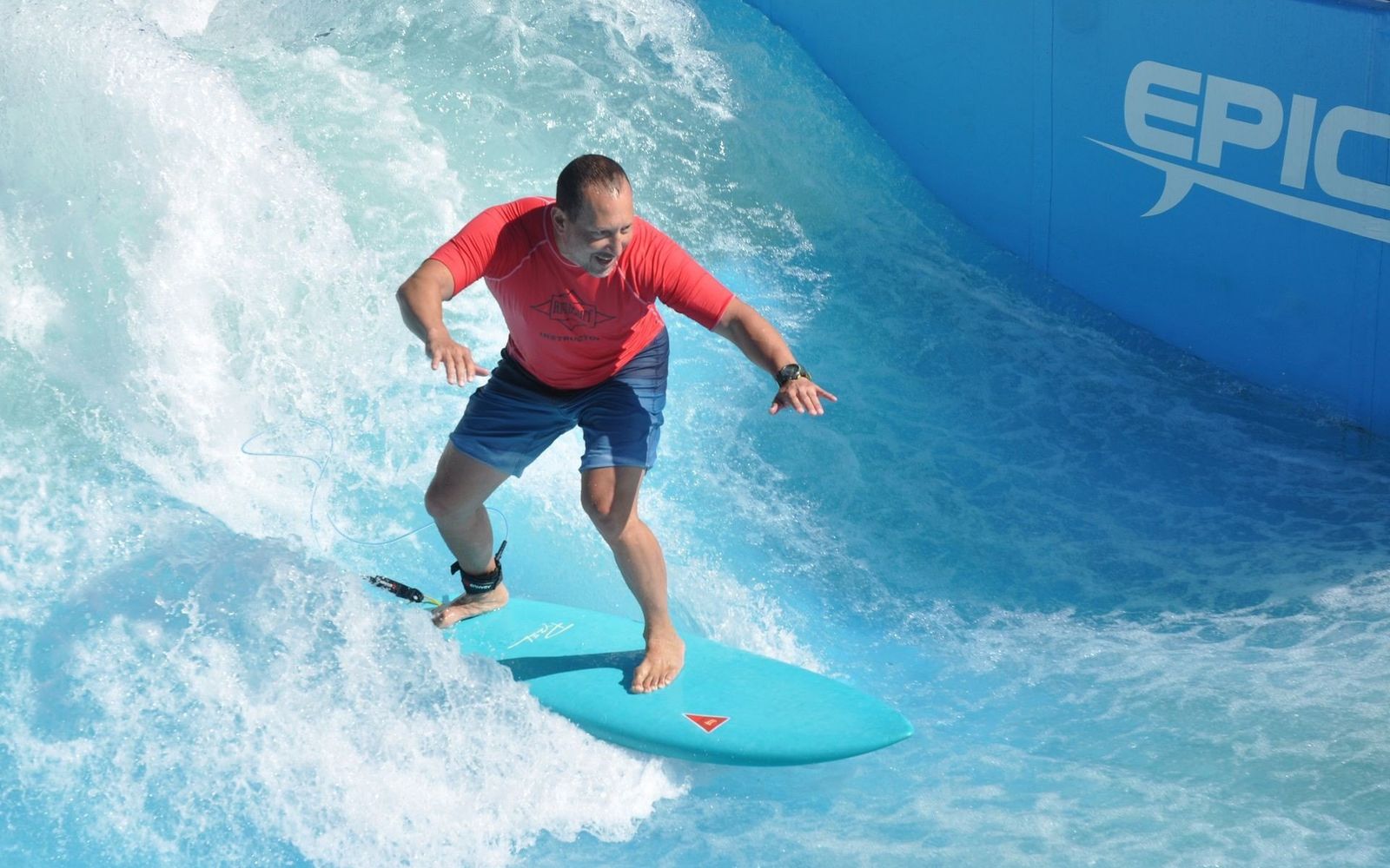 A surfer riding the EpicSurf standing wave at Heroes Paradise.