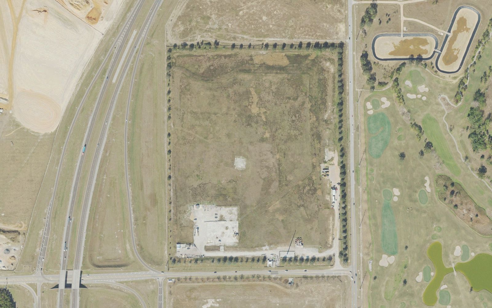 The site at 7902 Avalon Road in January 2023: the tree-lined rectangle in the middle is the former debris landfill, with State Road 429 on the left and Orange County National's golf course across Avalon Road on the right.
