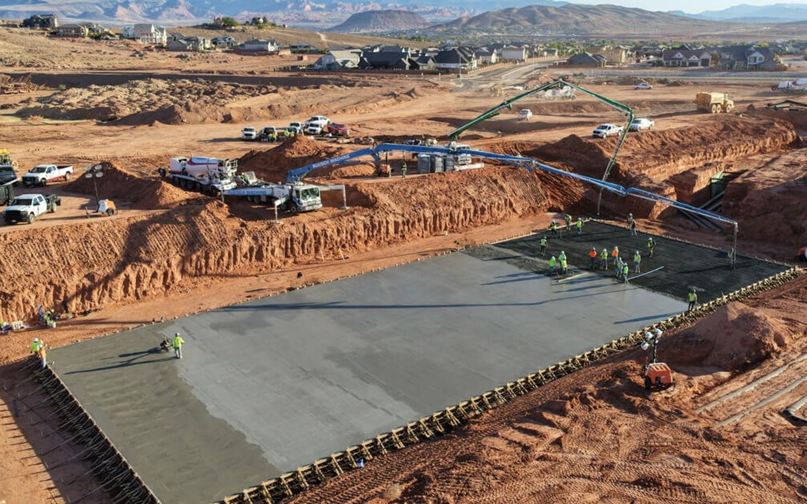 A concrete pour at Zion Shores during construction, with the southern Utah mesas behind