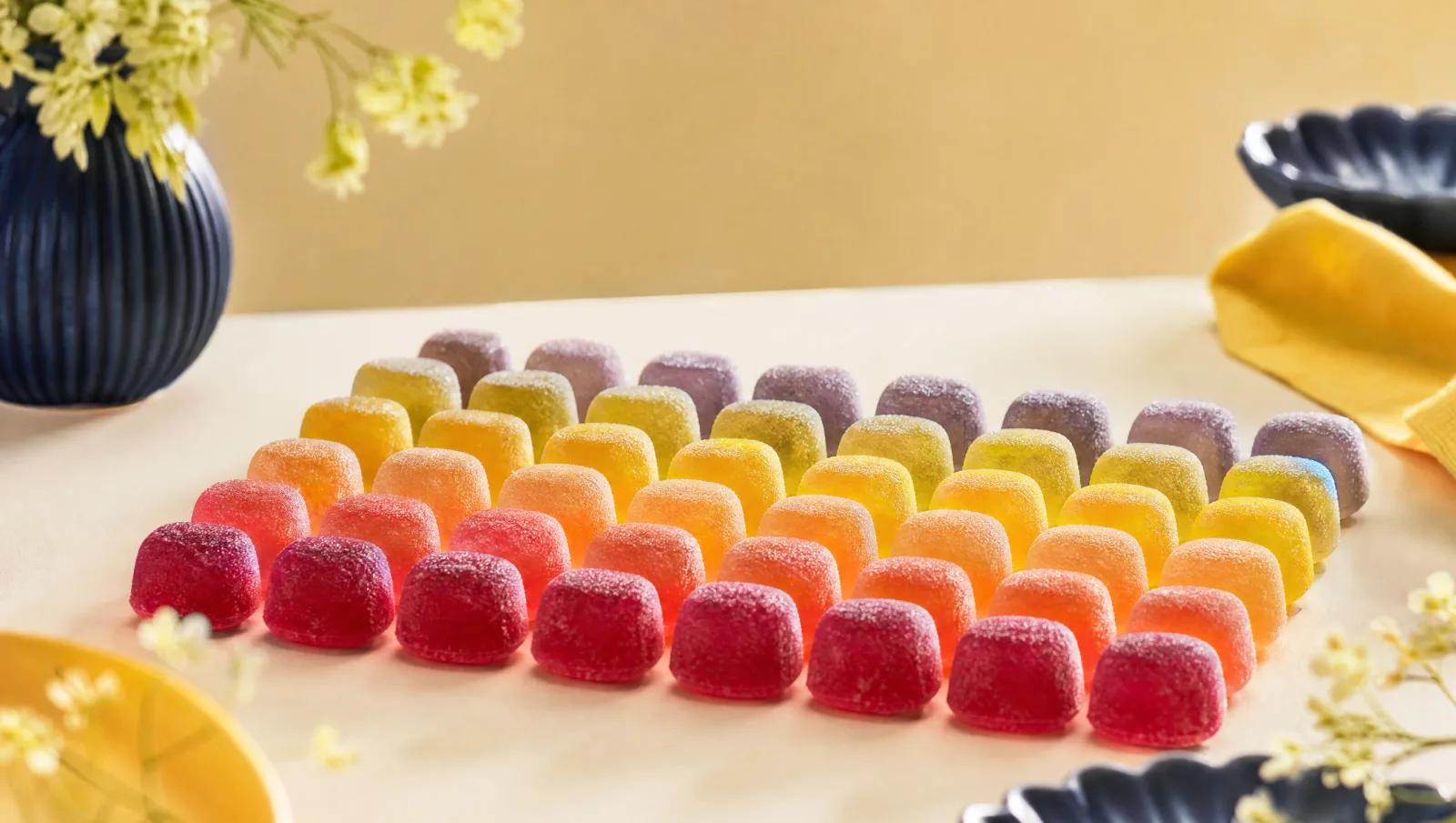 Translucent jelly sweets backlit to glow, in soft colour gradient rows.