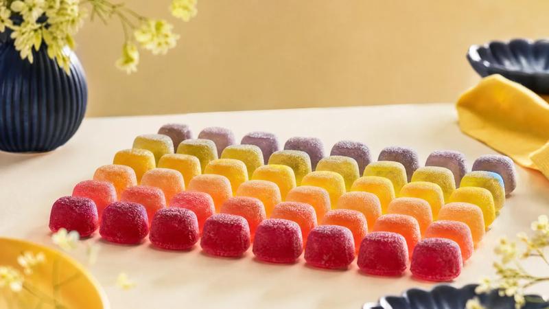 Translucent jelly sweets backlit to glow, in soft colour gradient rows.