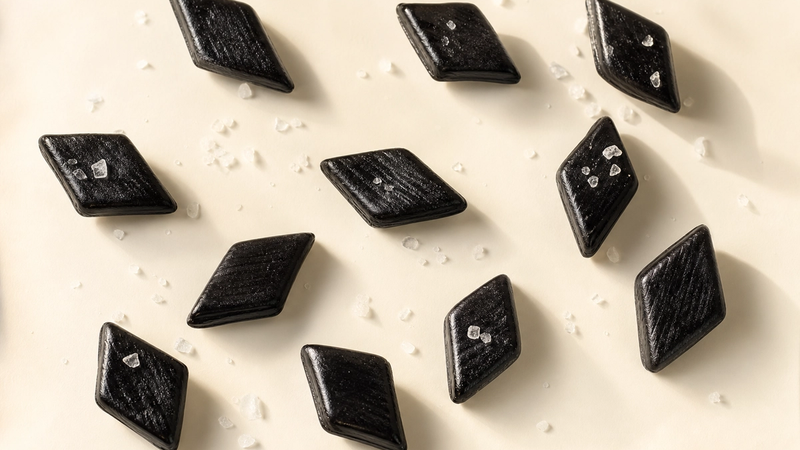Glossy black salty licorice pieces with salt