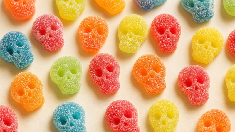 Colorful skull-shaped sour gummy candies