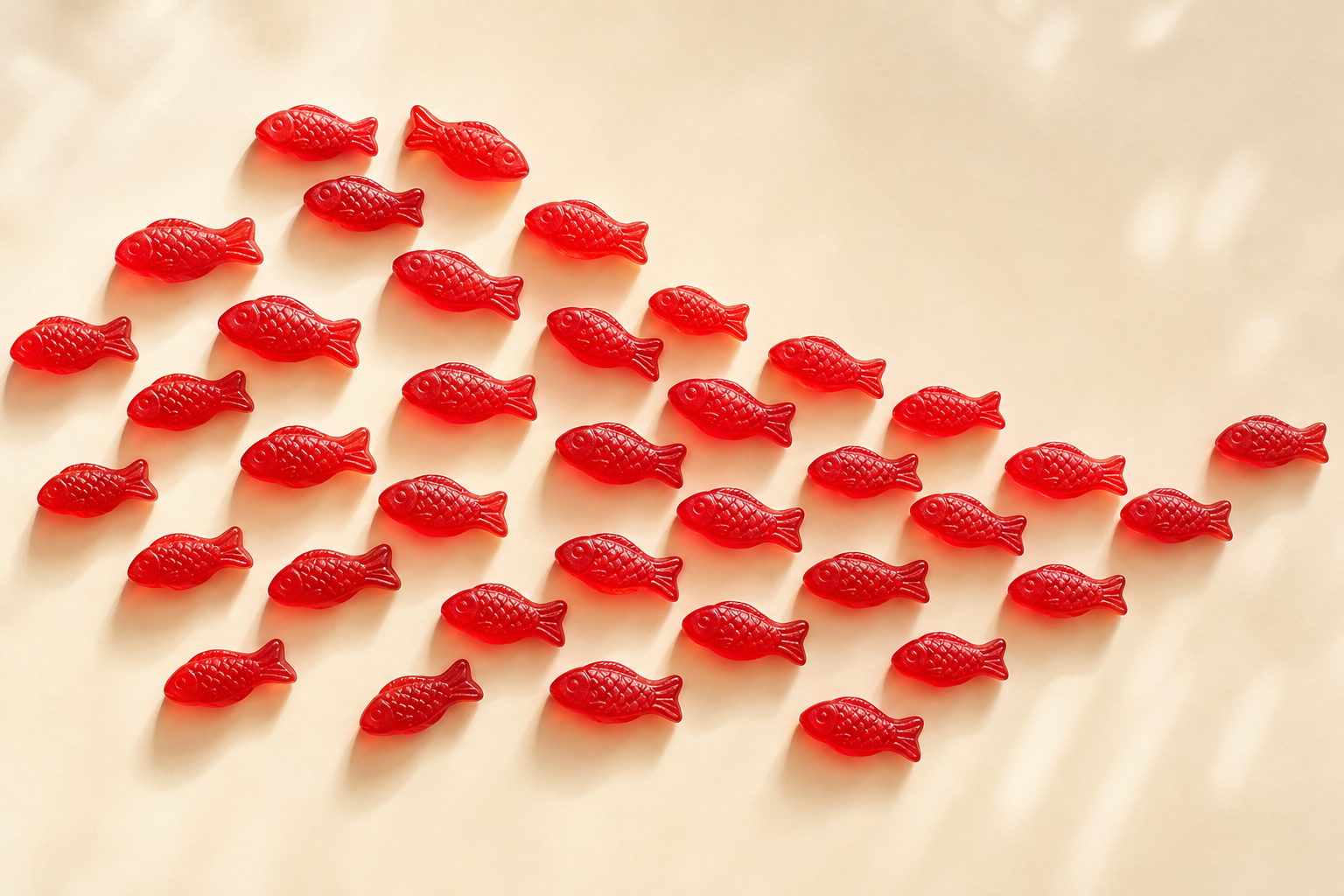 Red fish-shaped candies arranged like a school of fish