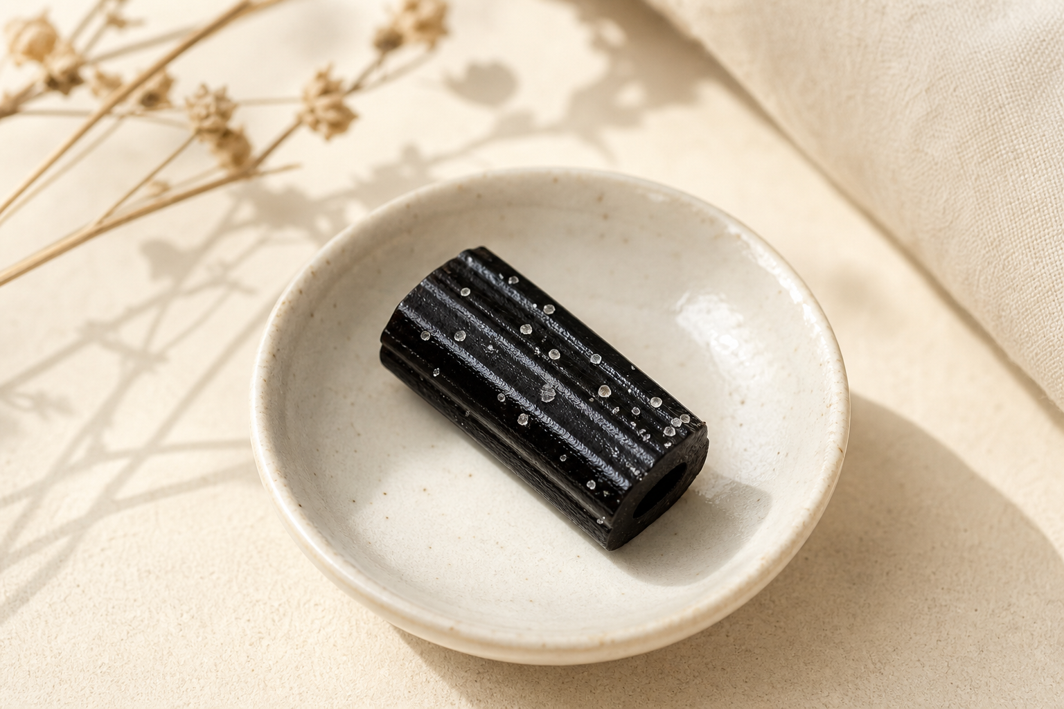 A piece of black salty licorice on a dish