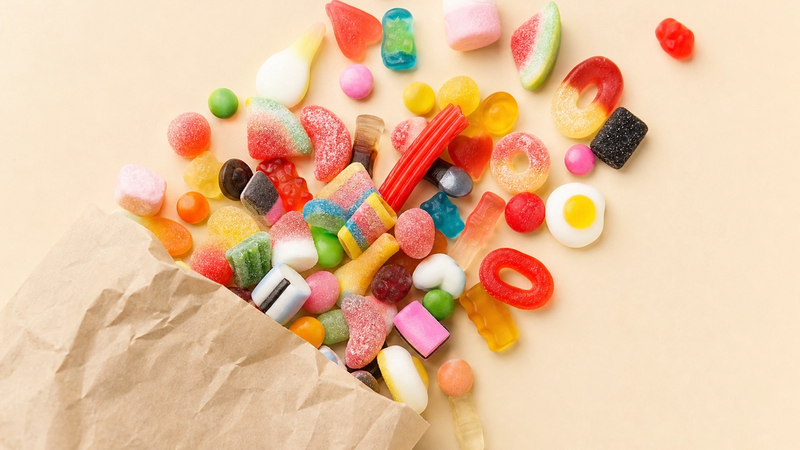 A paper bag of mixed pick-and-mix candy