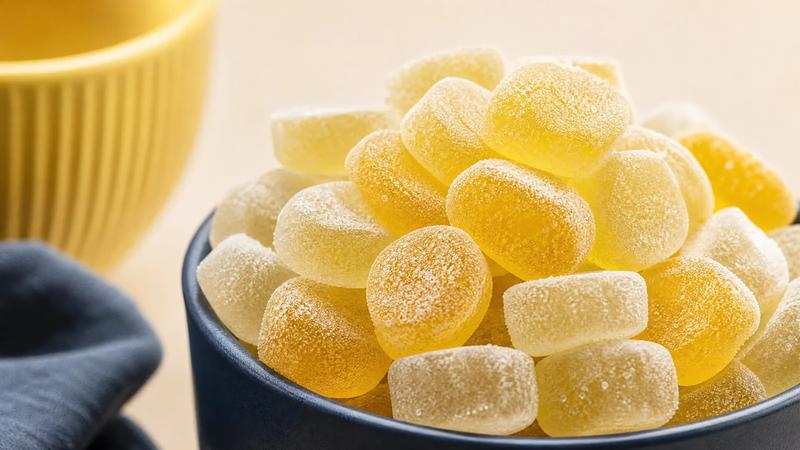 Heavily sanded sour sweets piled high, thick acid coating in macro.
