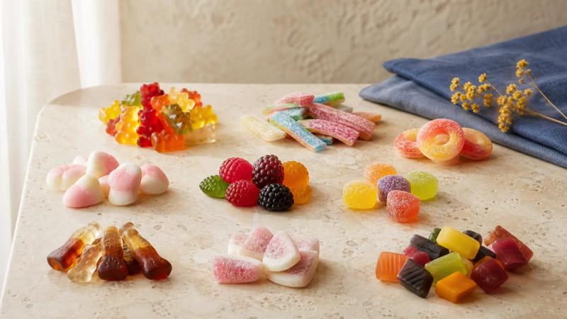 Small clusters of different gummy candies laid out side by side like a tasting flight.