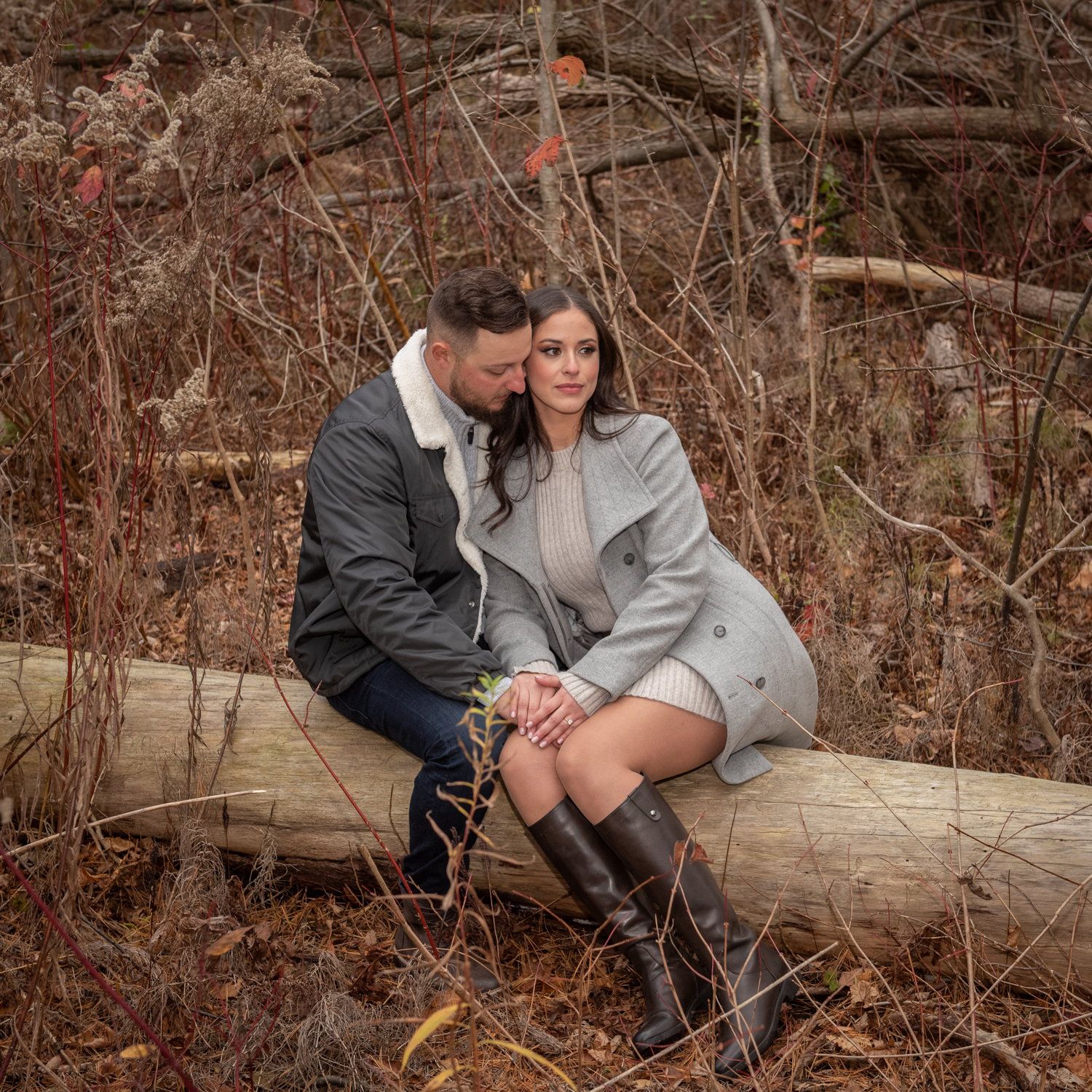 Larissa & Gianluca resting on a fallen log among dry autumn branches