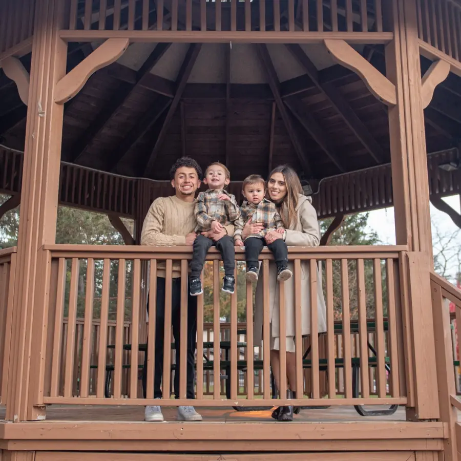 Wide view of Melanie & Harold's family on the steps of a park gazebo