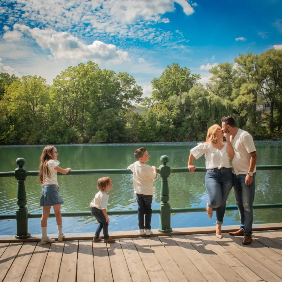 Sara & Rocco's family on a lakeside boardwalk, their four children running ahead