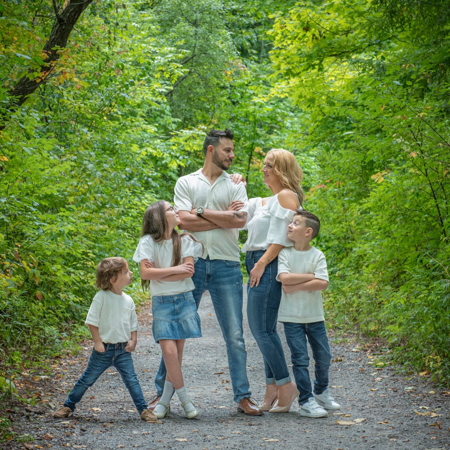 Sara & Rocco's children leaning in around them on a park path
