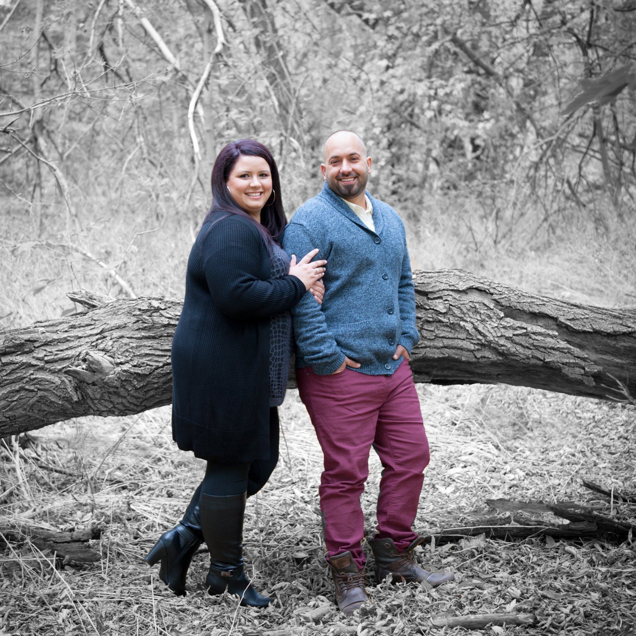 A couple standing beside a fallen log at Mill Pond, the background desaturated