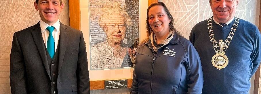 } Neels Ferriera, General Manager of the Skiddaw Hotel; Vanessa Metcalfe, Tourism Manager at Keswick Tourism Association and Alan Dunn, Keswick Mayor photographed with the Queen’s portrait