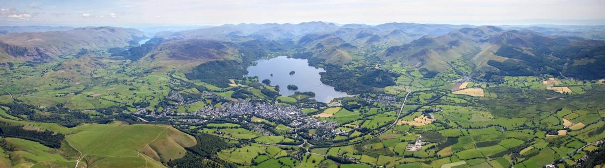 An aerial view over Keswick town with Derwentwater and the surrounding fells