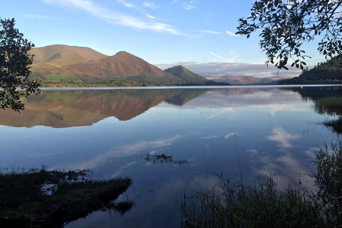 Bassenthwaite Lake lying still and framed by overhanging trees