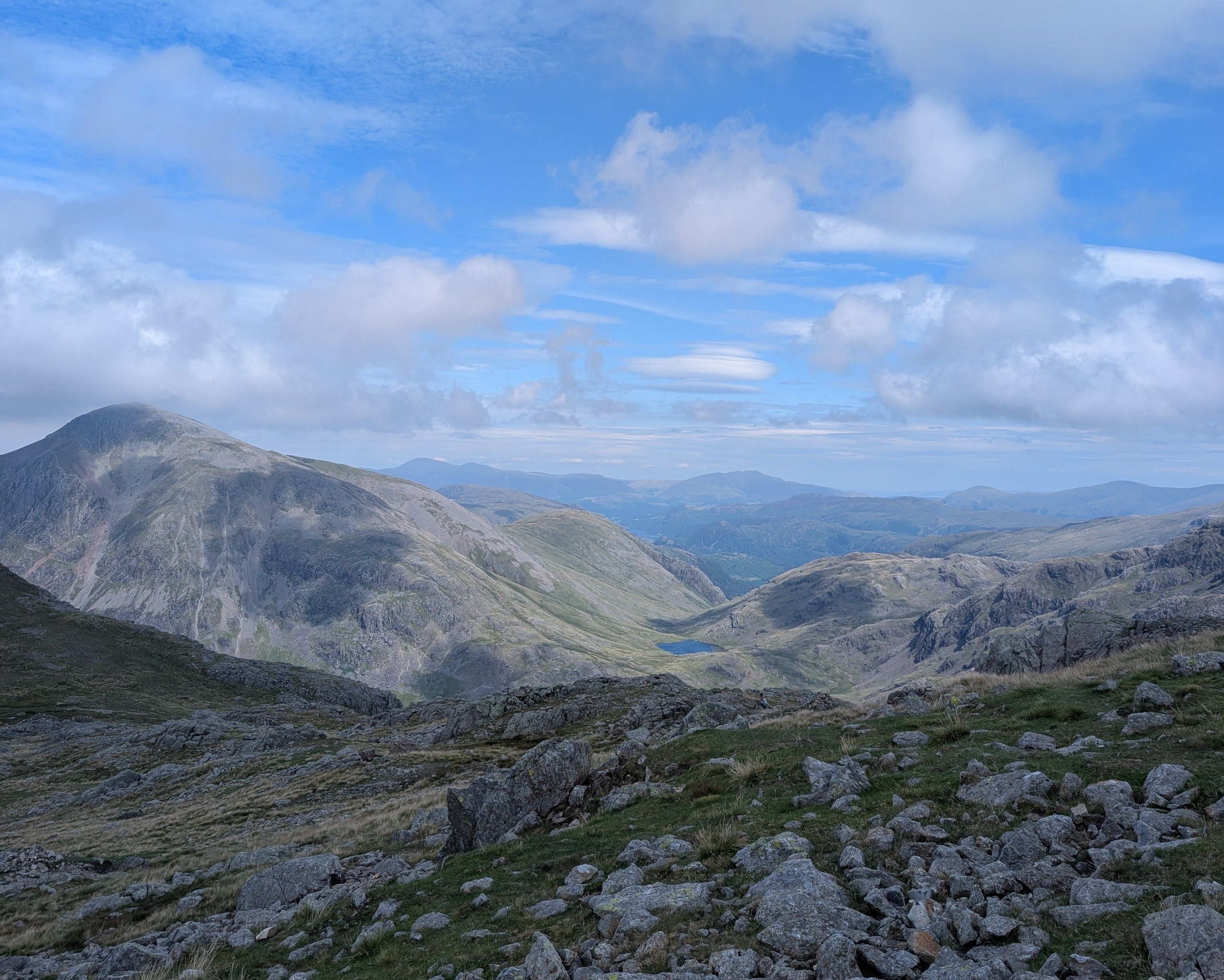 A narrow path picking along the top of a bare rocky ridge
