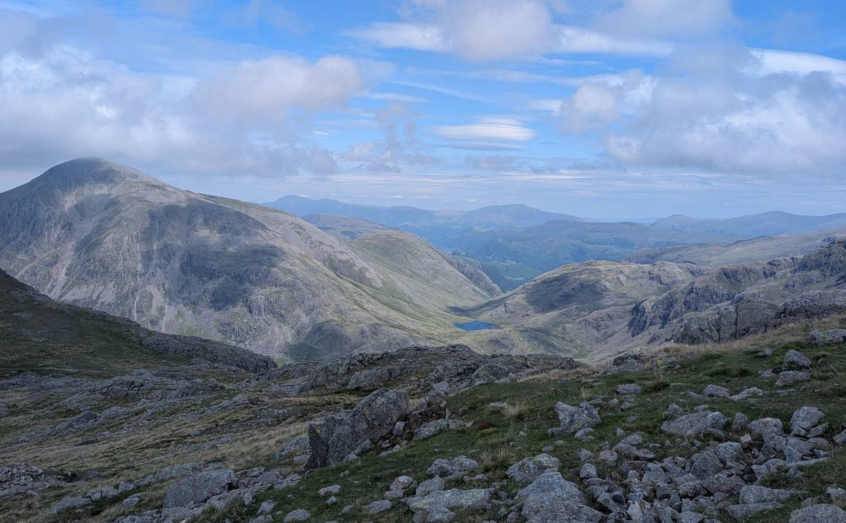 A narrow path picking along the top of a bare rocky ridge