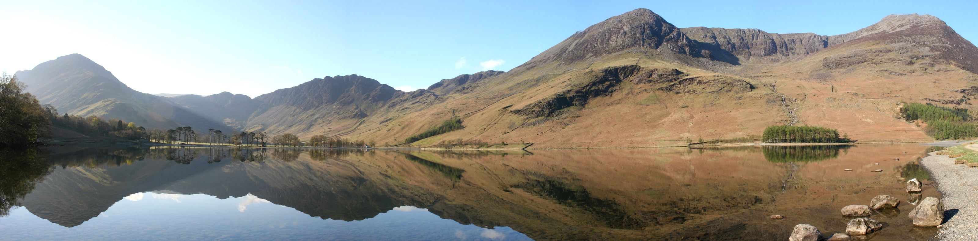 A range of mountains reflected whole in a lake lying completely still