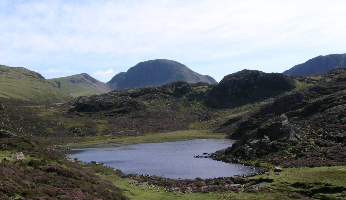 A rocky outcrop beside a mountain tarn on the open fell