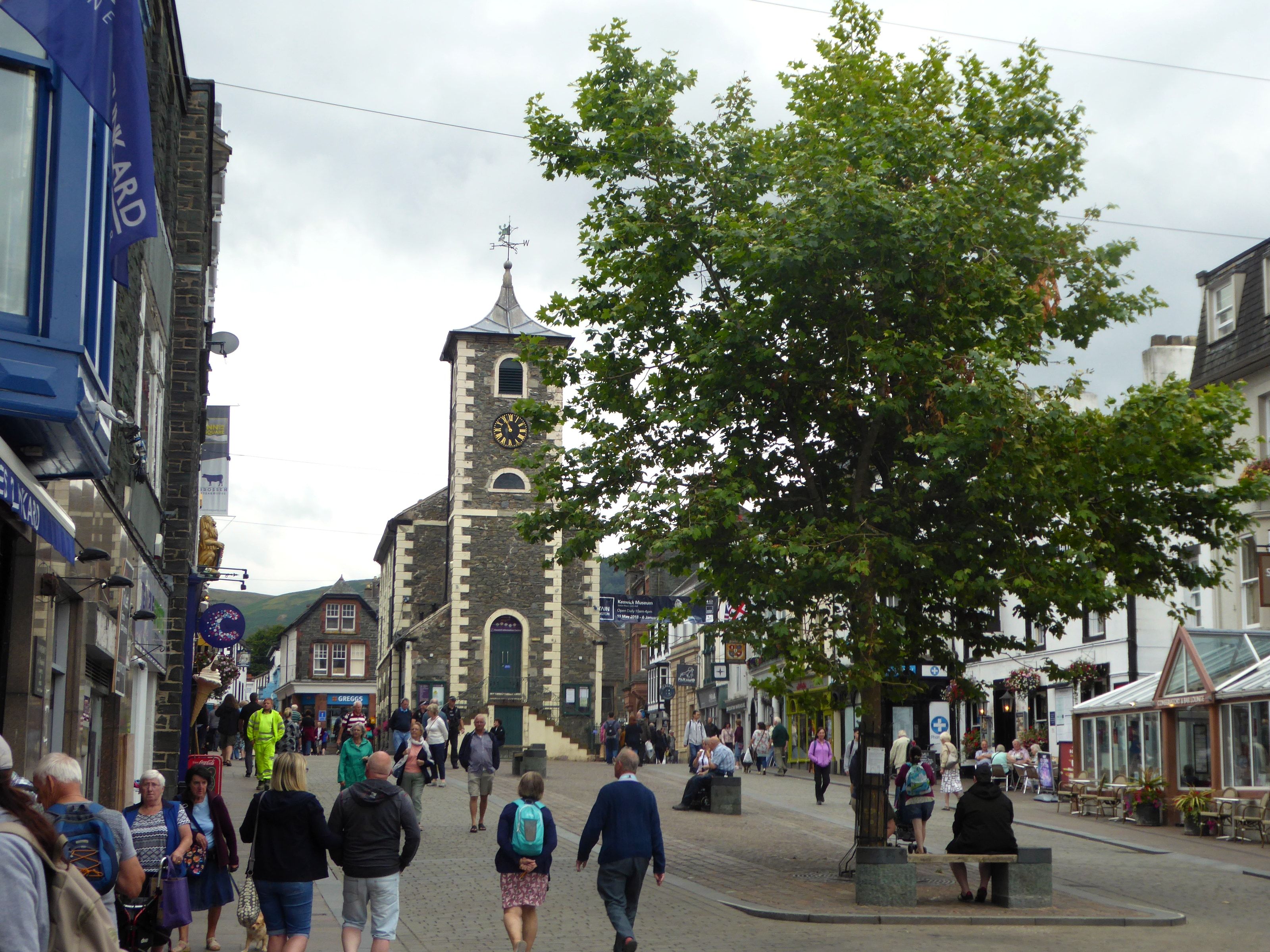 The Moot Hall clock tower above a busy Keswick market street