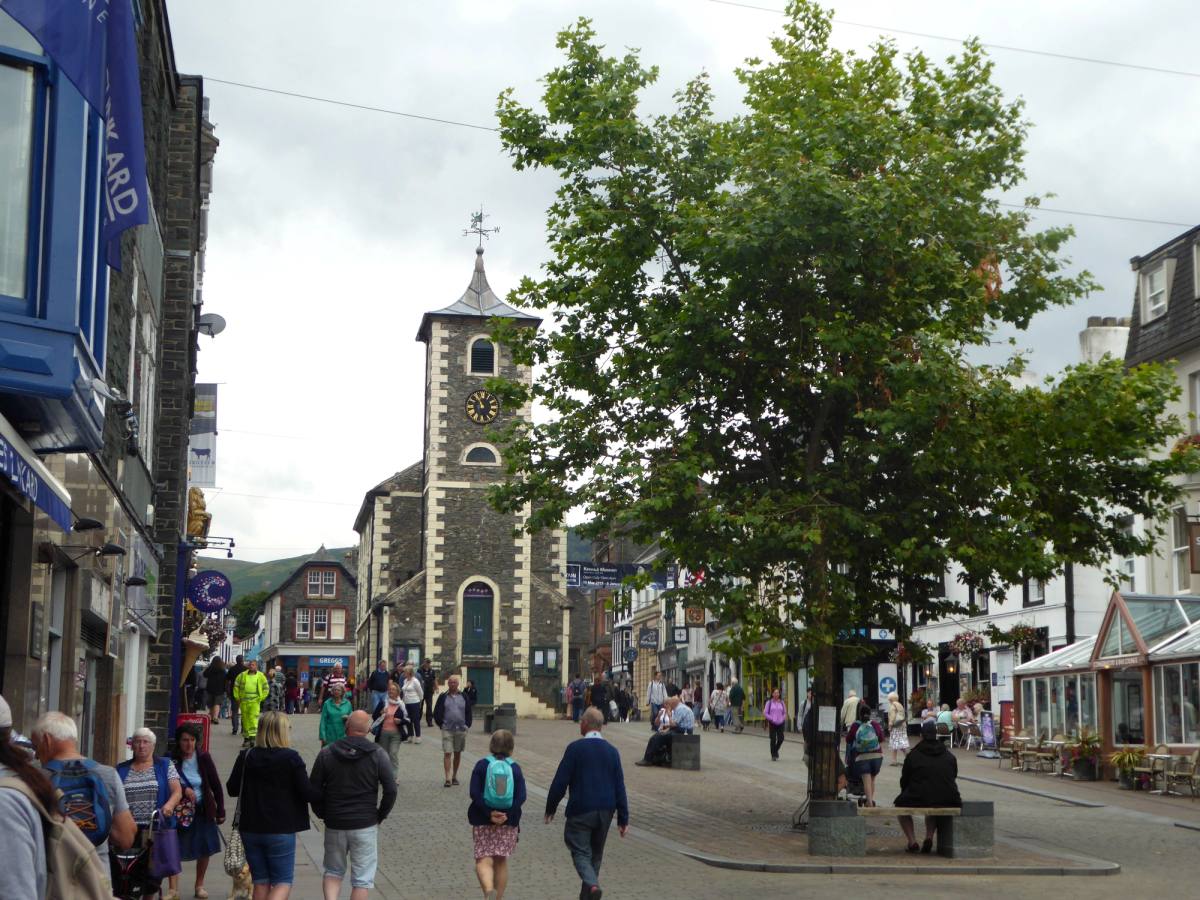 The Moot Hall clock tower above a busy Keswick market street