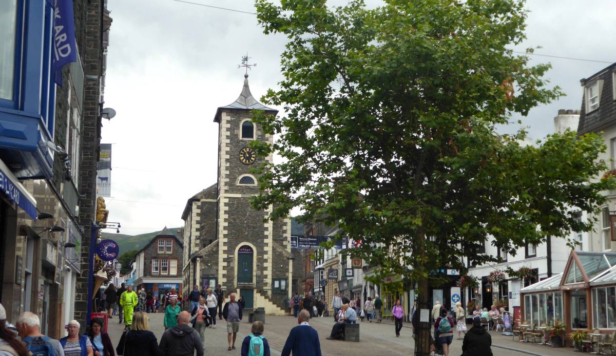 The Moot Hall clock tower above a busy Keswick market street