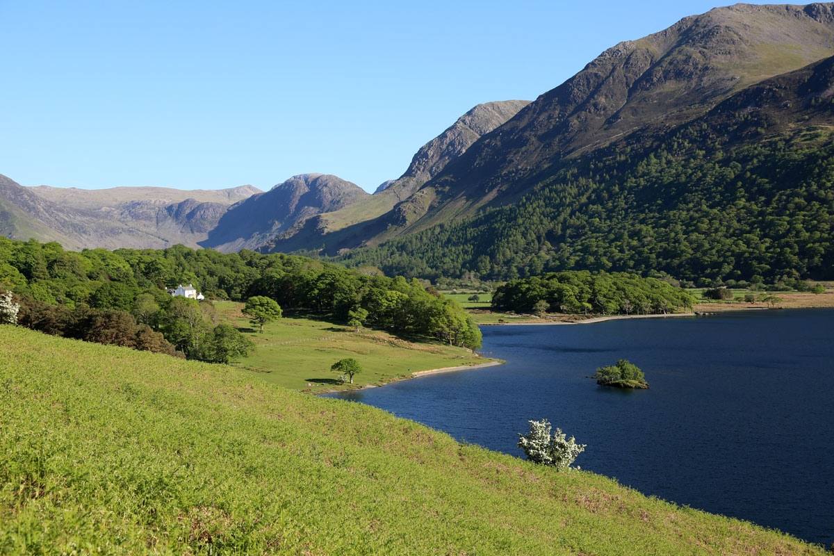Crummock Water below a bracken slope with the high fells beyond