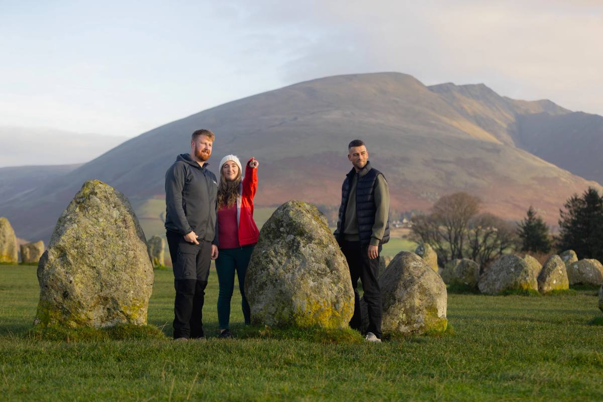 The standing stones of Castlerigg at dawn with mist lying across the fells behind