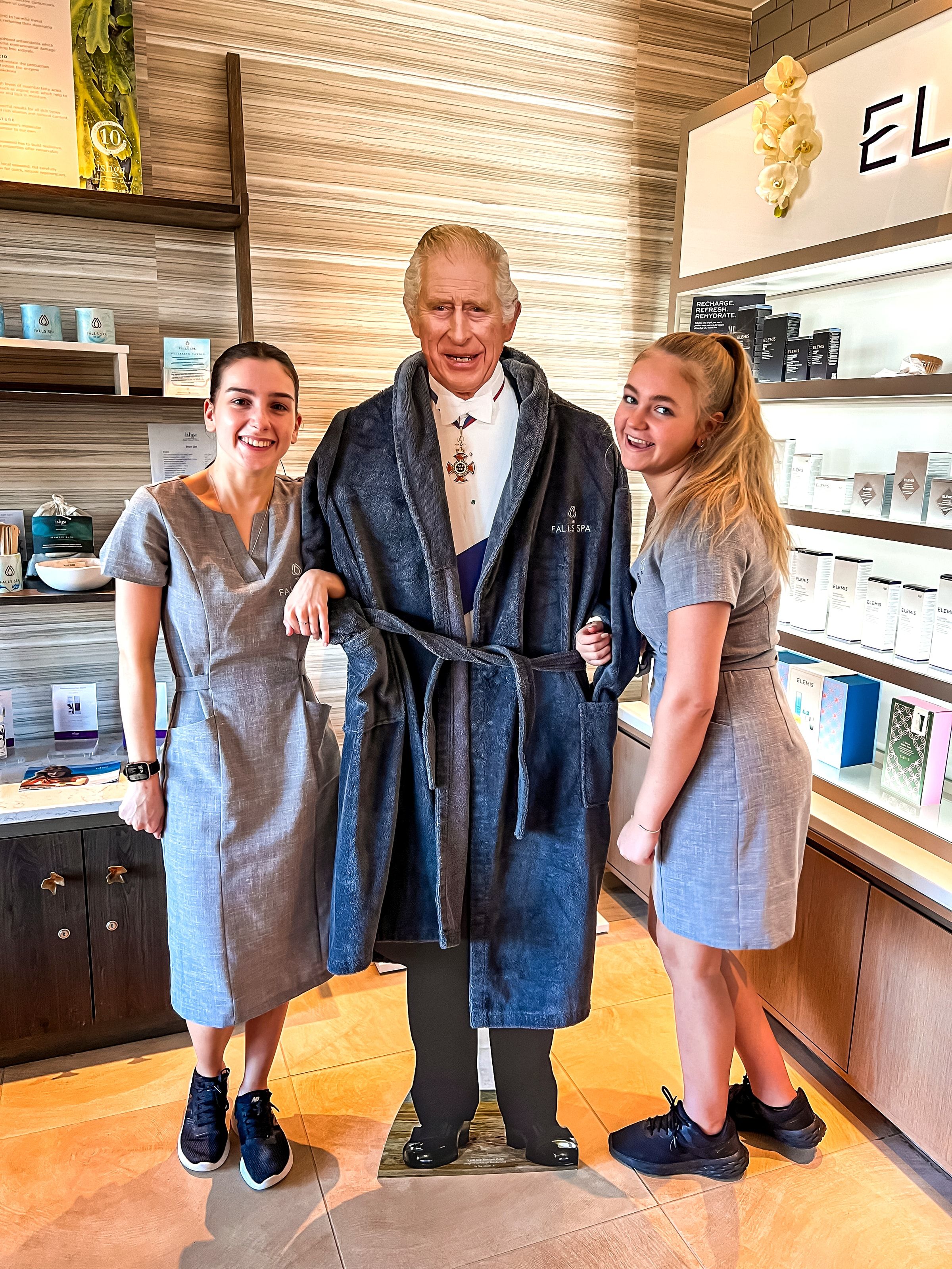 Cut out of King Charles with two staff members at Falls Spa