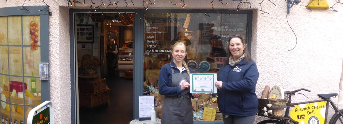 Hayley Peacock, owner of Keswick Cheese Deli being presented with the winners certificate by Vanessa Metcalfe, KTA Tourism Manager