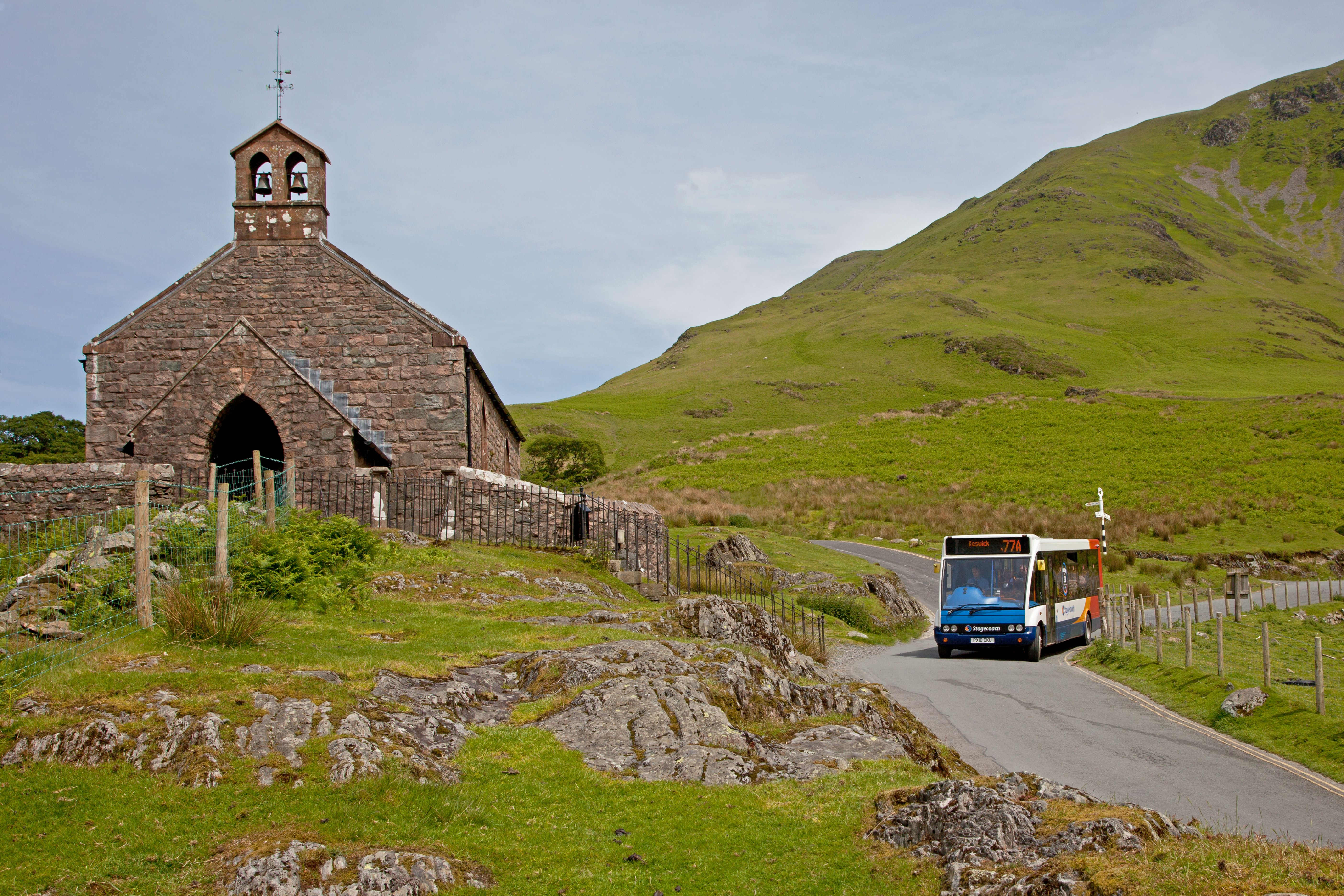 bus driving past st james church in buttermere