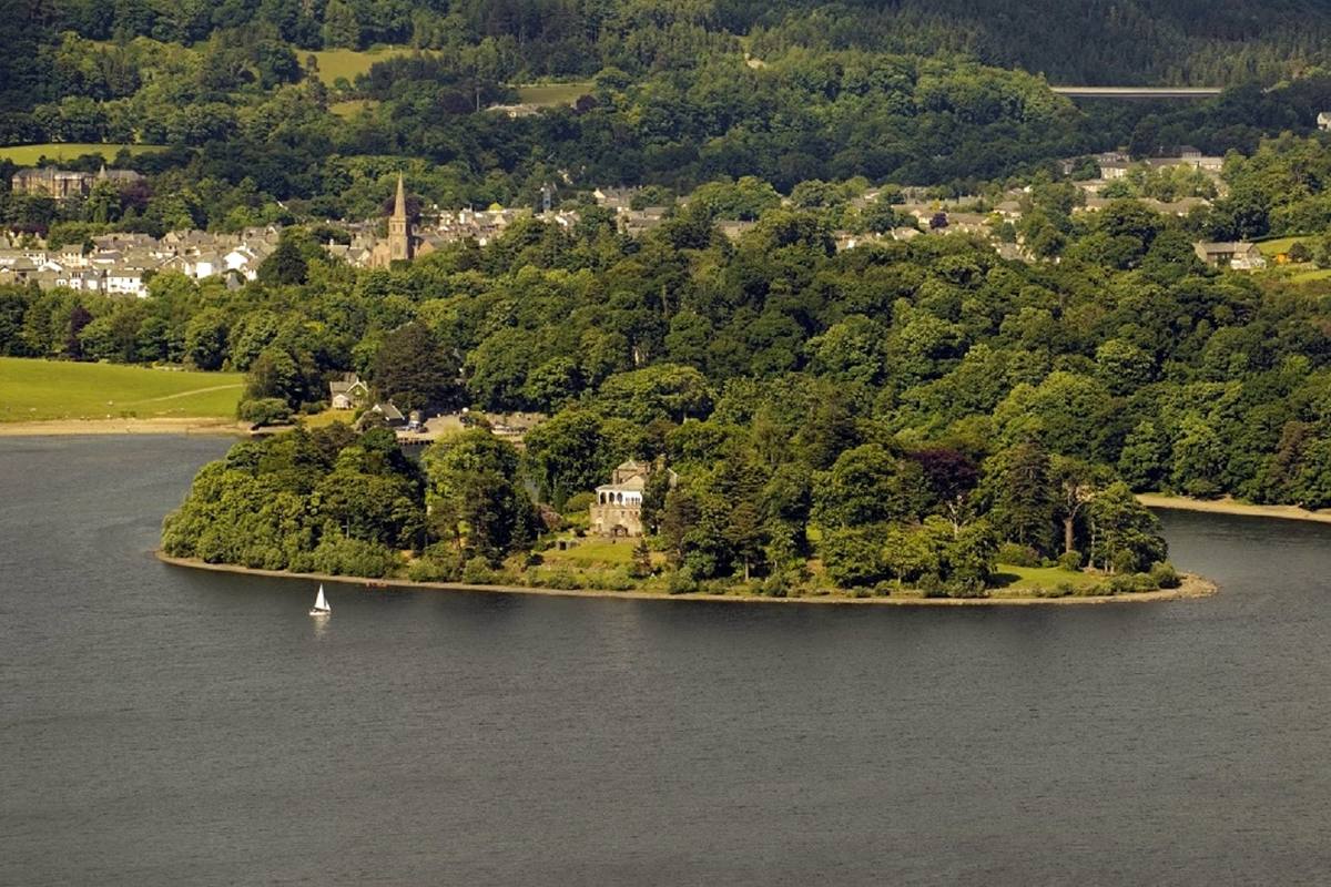 The wooded island of Derwent Isle, with its house among the trees at the water’s edge