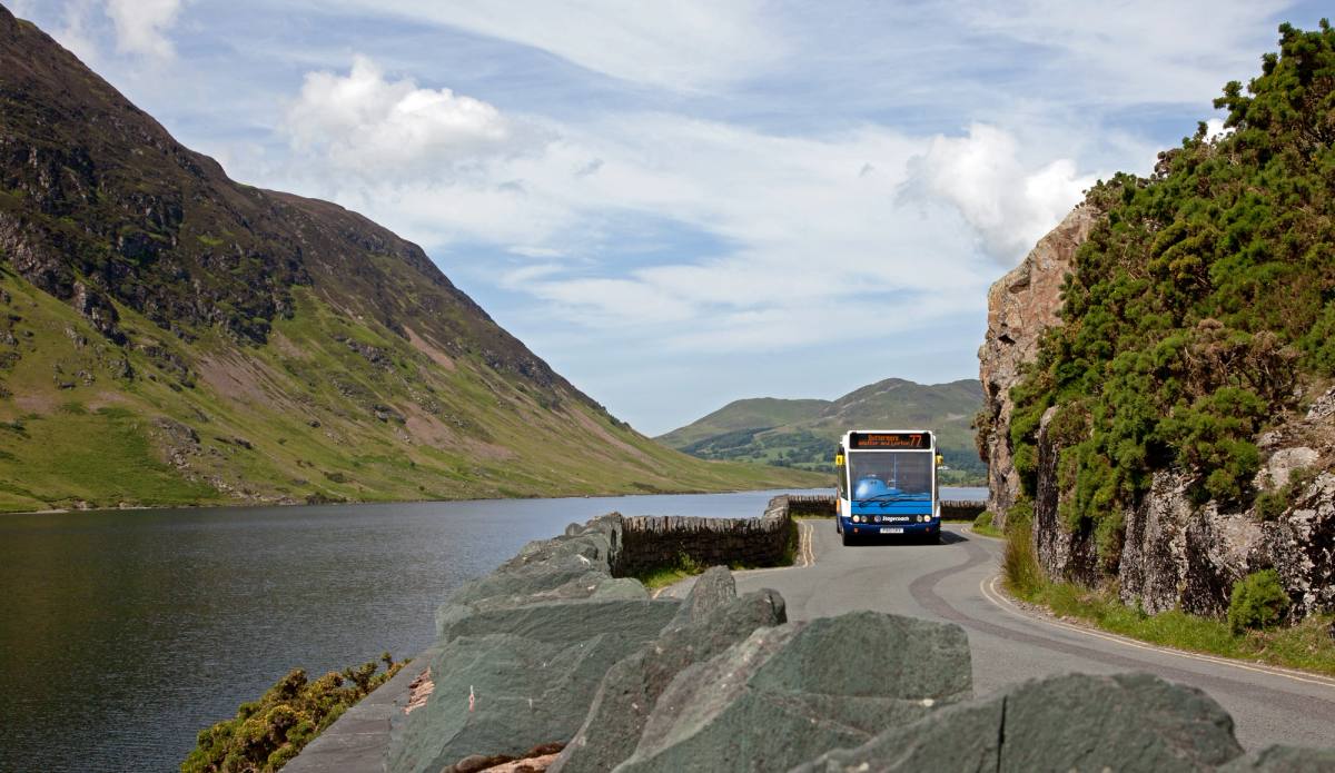 Bus coming around the windy narrow road next to crummock water lake
