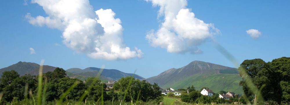 View across a field to Portinscale