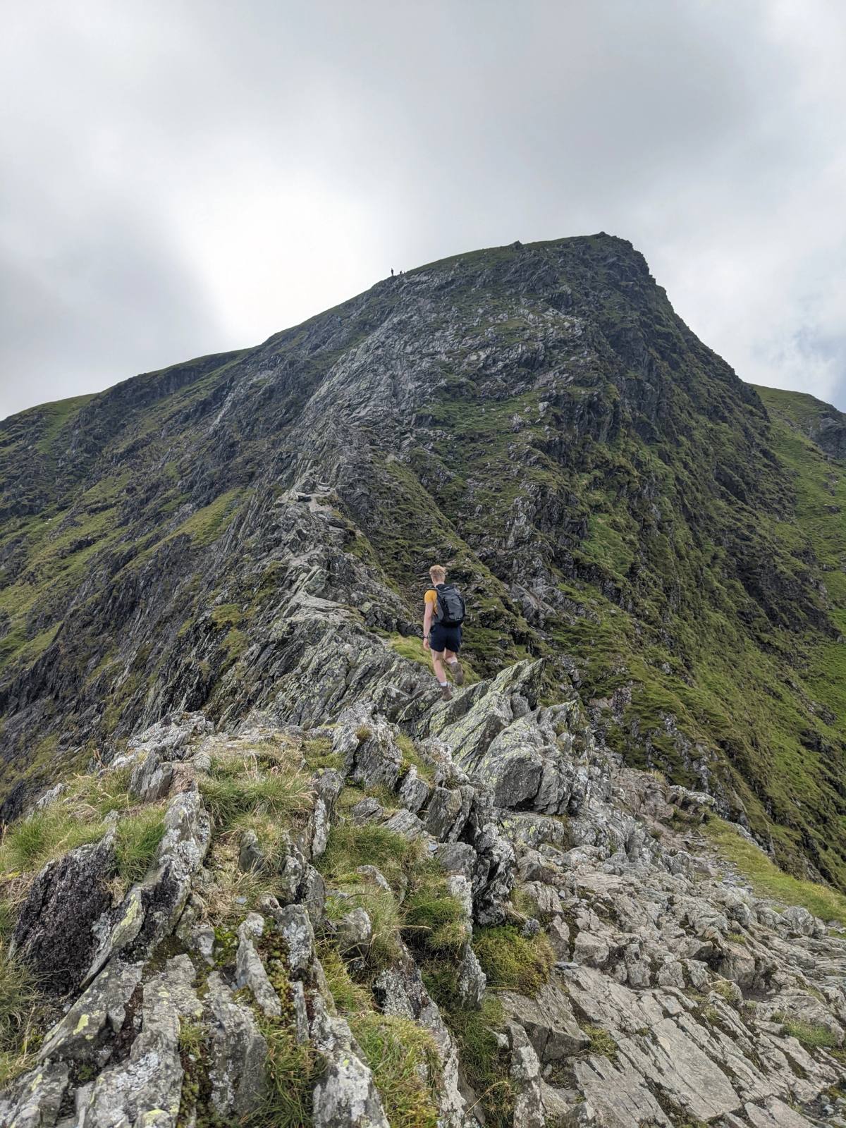A narrow path picking along the top of a bare rocky ridge