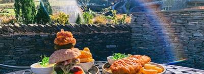 The Mighty Burger and the Local Cider Battered Fish & Chips, two of the most popular dishes available on the Lodore Falls Hotel & Spa outdoor dining menus