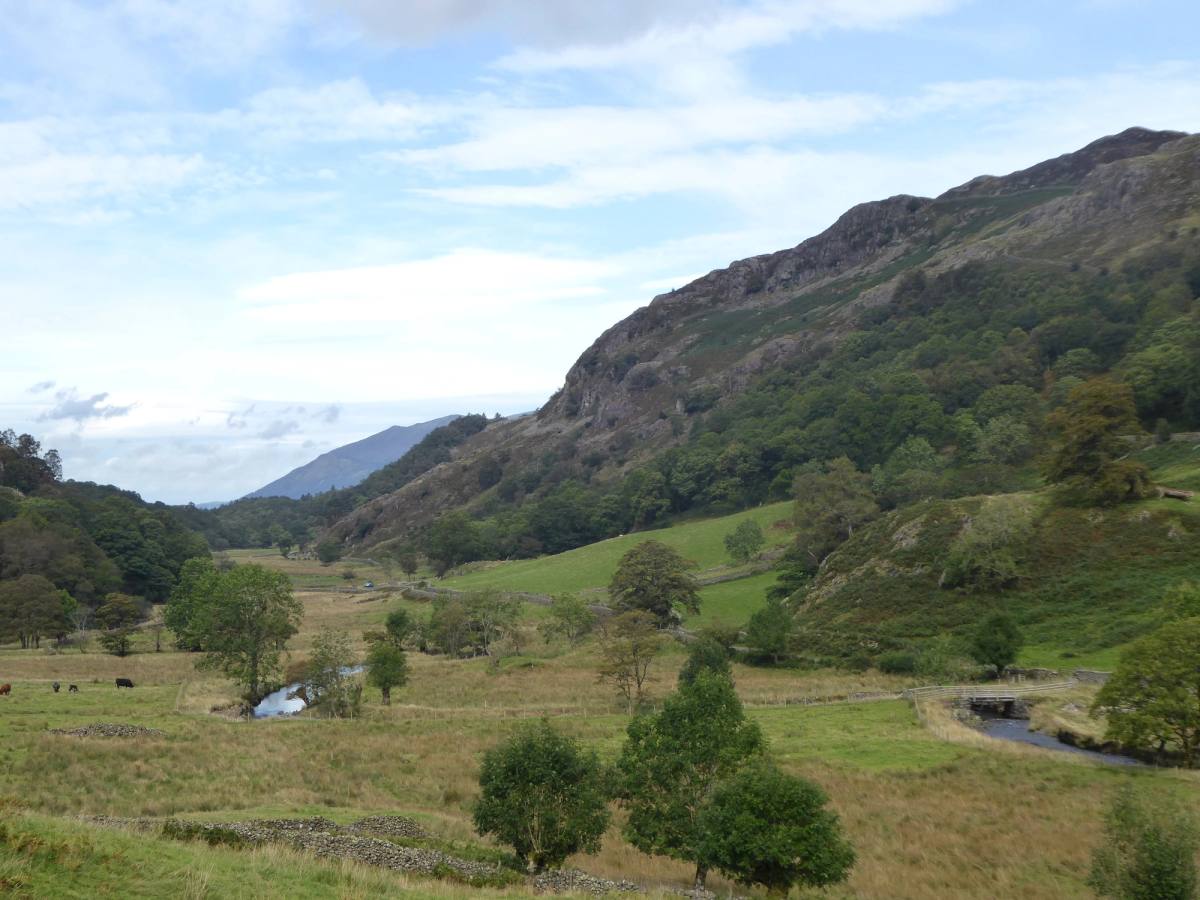 The narrow Watendlath valley with rough pasture and steep fells closing it in