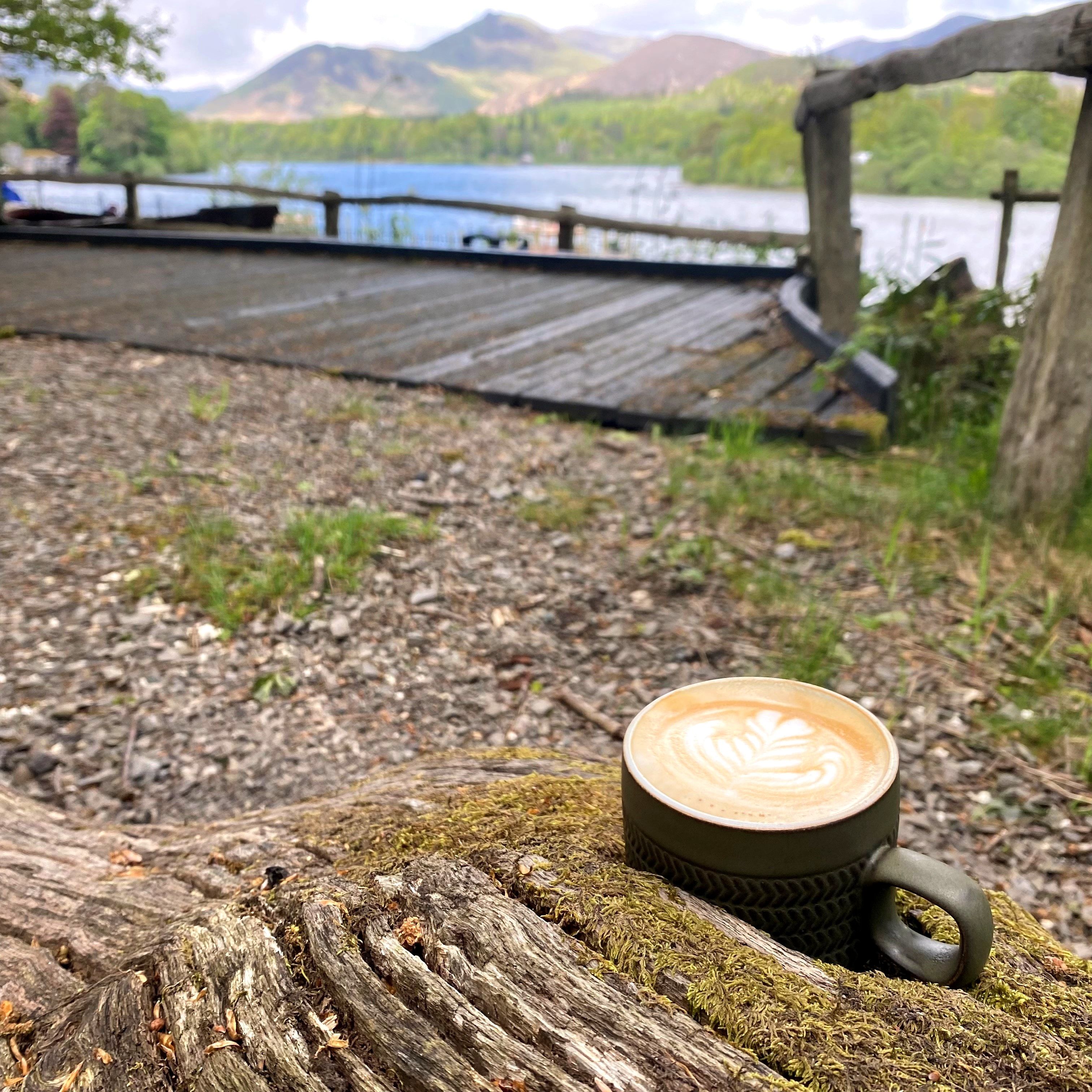 Cup of coffee with view over Derwentwater in the background